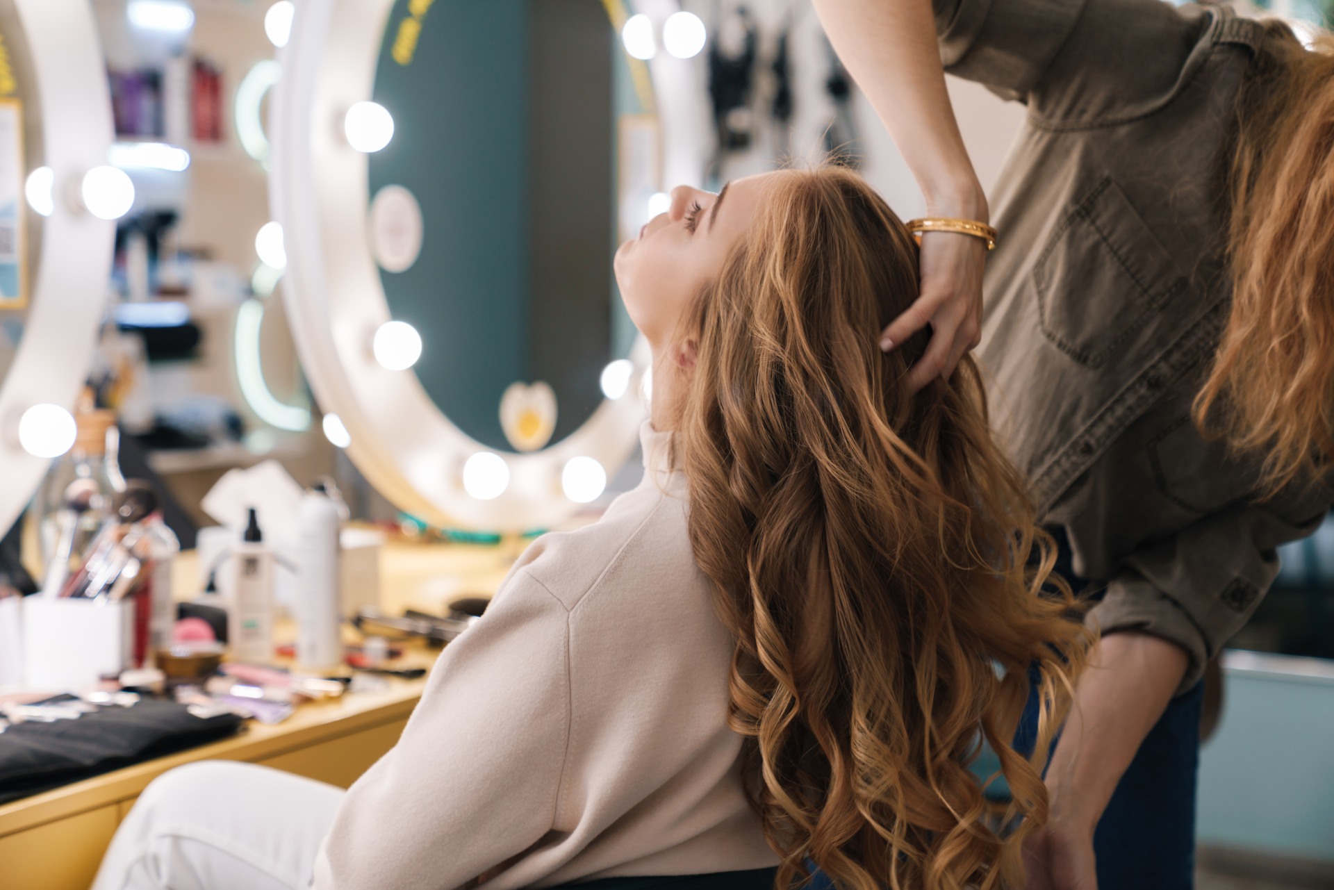 Hairdresser styling her client's hair